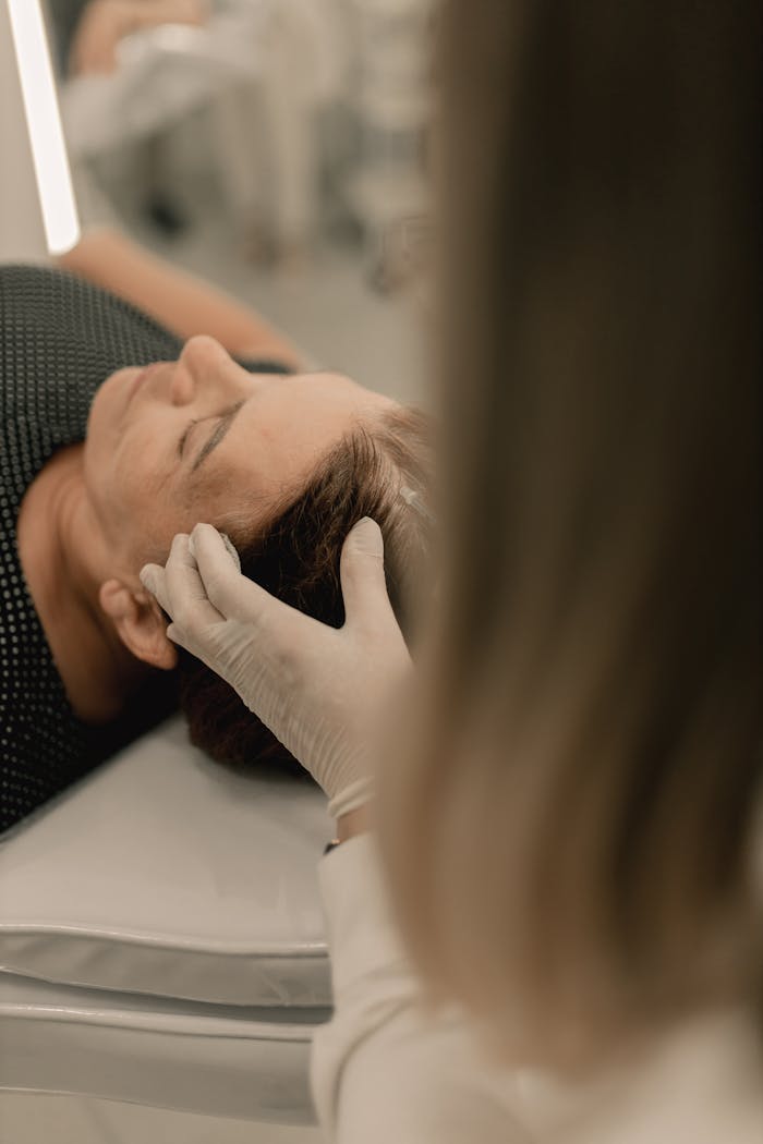 about-02 A woman receives a relaxing facial massage in a calm spa environment.