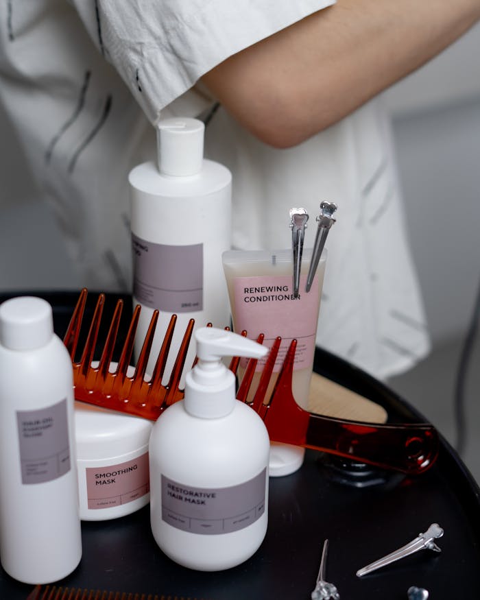 about-img A collection of haircare products including shampoos, conditioners, and combs neatly arranged on a table.